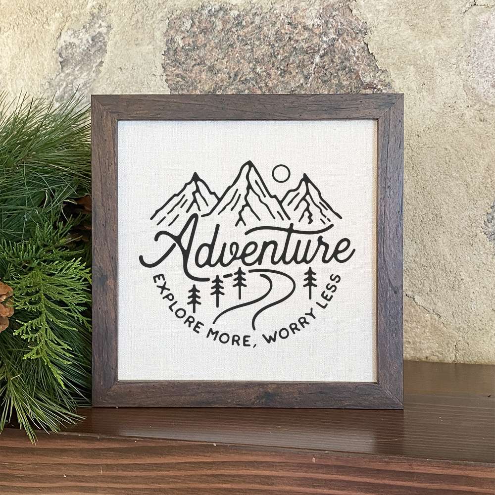Adventure-Explore More framed sign with a wood frame and linen-look background, perfect for home decor.