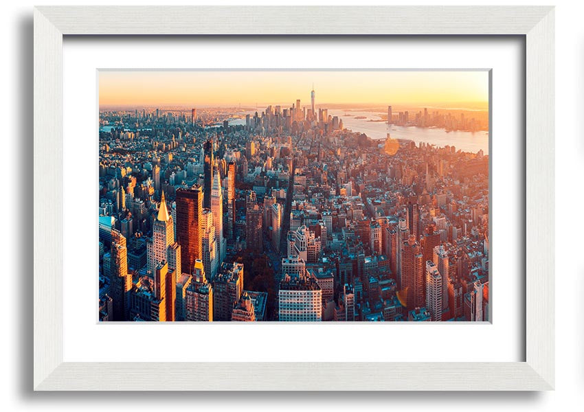 Aerial view of a city at sunset, framed print with vibrant colors and intricate details, ready to hang.