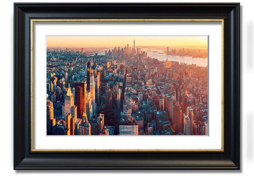 Aerial view of a city at sunset, framed print with vibrant colors and intricate details, ready to hang.