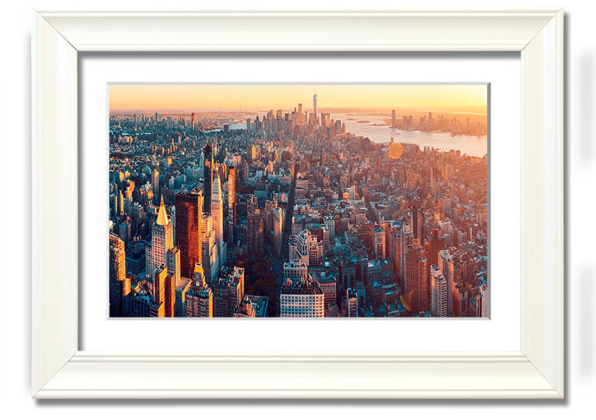 Aerial view of a city at sunset, framed print with vibrant colors and intricate details, ready to hang.