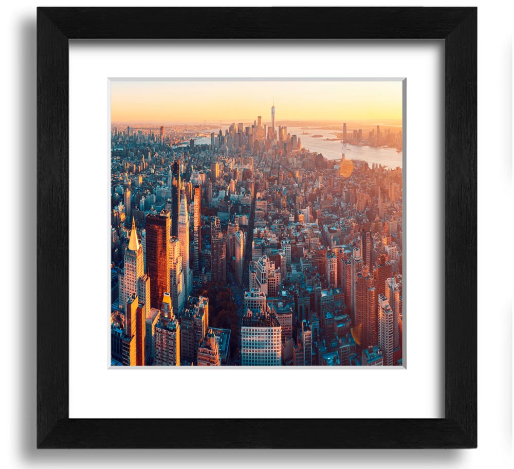 Aerial view of a city at sunset, framed in a stylish square frame, showcasing vibrant colors and intricate details.