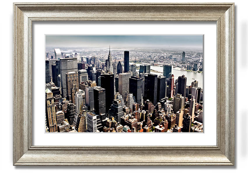 Framed print of an aerial view of New York City showcasing the skyline and urban landscape.