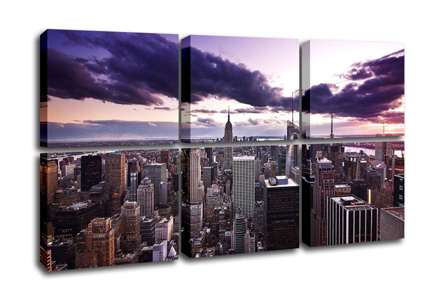 Aerial view of New York City at dusk, showcasing illuminated skyscrapers and vibrant sunset colors.