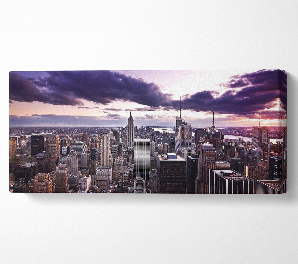 Aerial view of New York City skyline at dusk, showcasing vibrant colors and city lights.