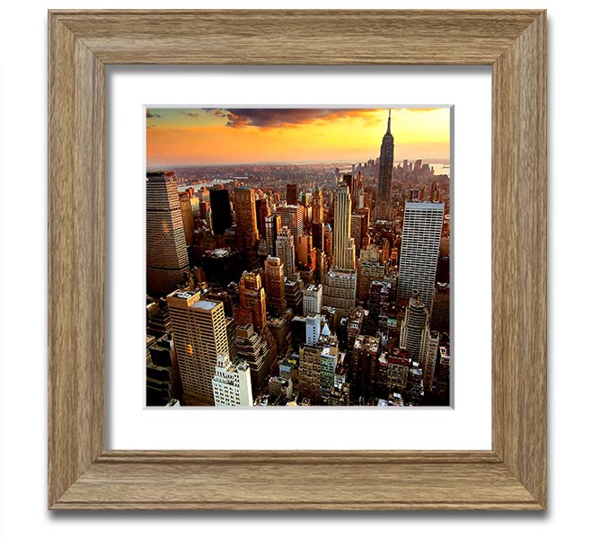 Aerial view of New York City at sunset, framed in a square frame, showcasing vibrant colors and iconic skyline.