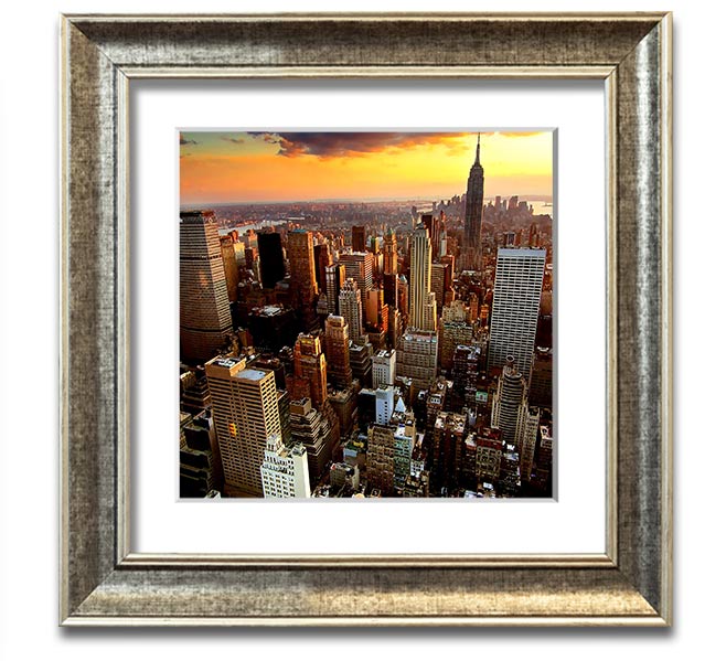 Aerial view of New York City at sunset, framed in a square frame, showcasing vibrant colors and iconic skyline.