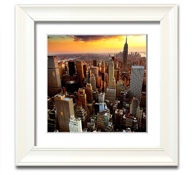 Aerial view of New York City at sunset, framed in a square frame, showcasing vibrant colors and iconic skyline.