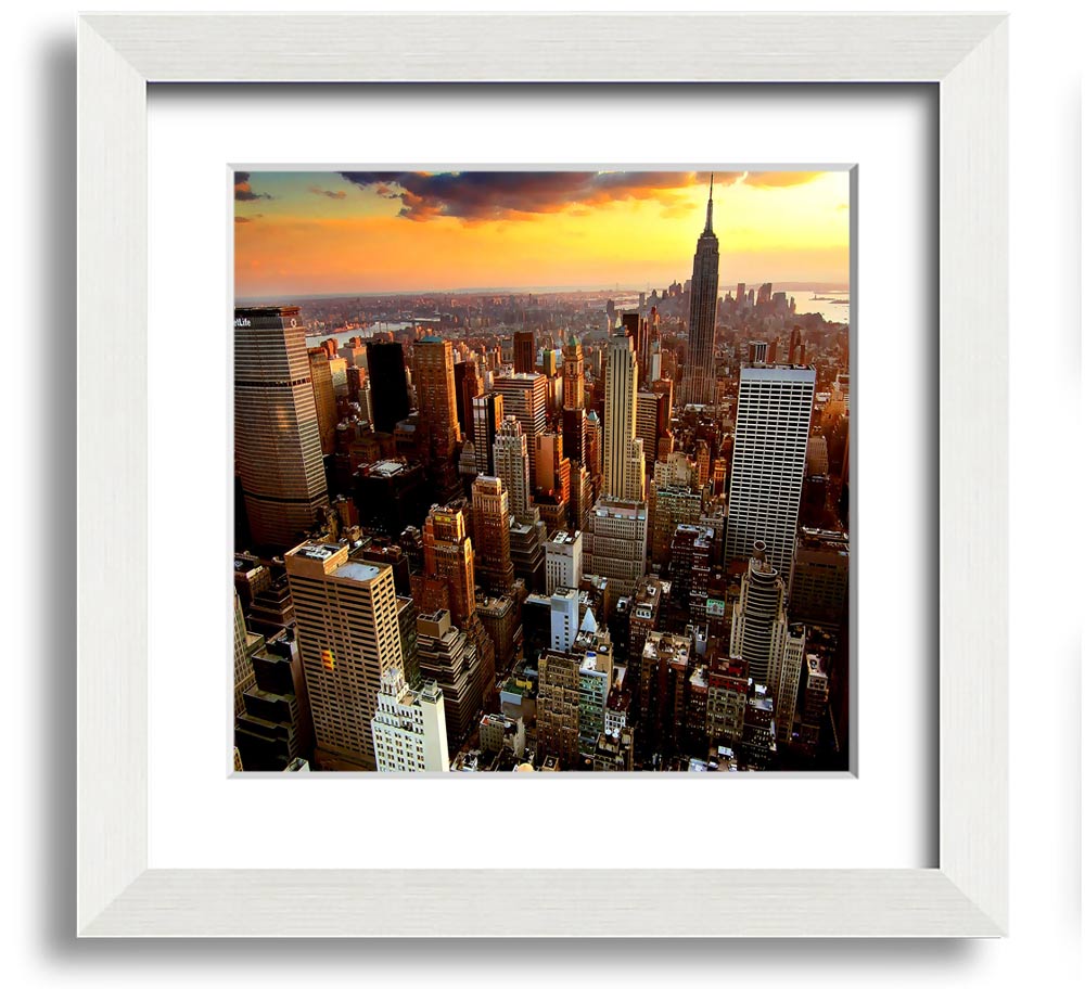Aerial view of New York City at sunset, framed in a square frame, showcasing vibrant colors and iconic skyline.