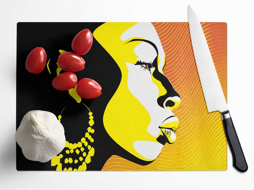 A beautifully designed chopping board featuring an African female bathed in golden light, made from durable tempered glass with a chinchilla ripple effect.