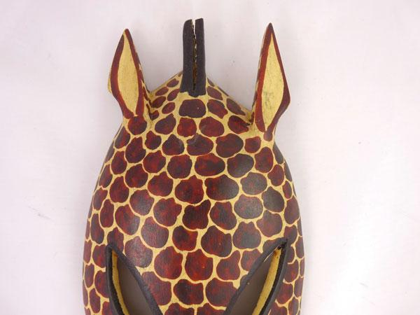 Handcrafted African Giraffe Head Wooden Mask showcasing intricate patterns and natural wood finish, perfect for home decor.