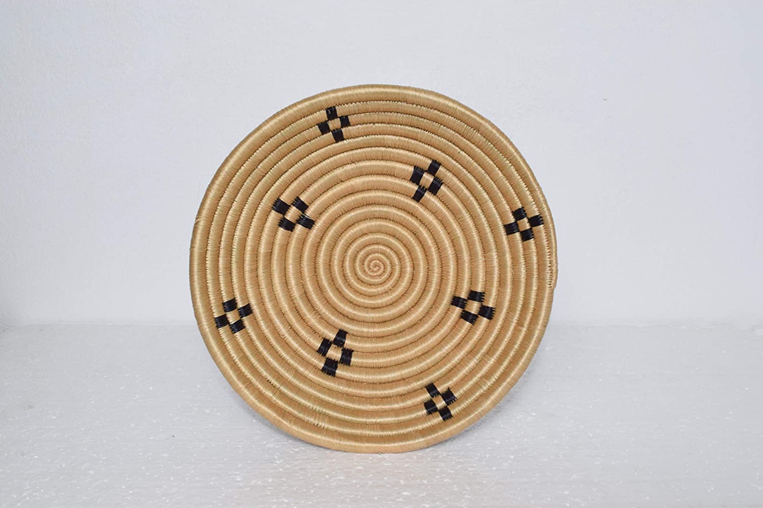 A beautifully handwoven African sisal basket from Rwanda, showcasing intricate patterns and vibrant colors, perfect for home decor or storage.