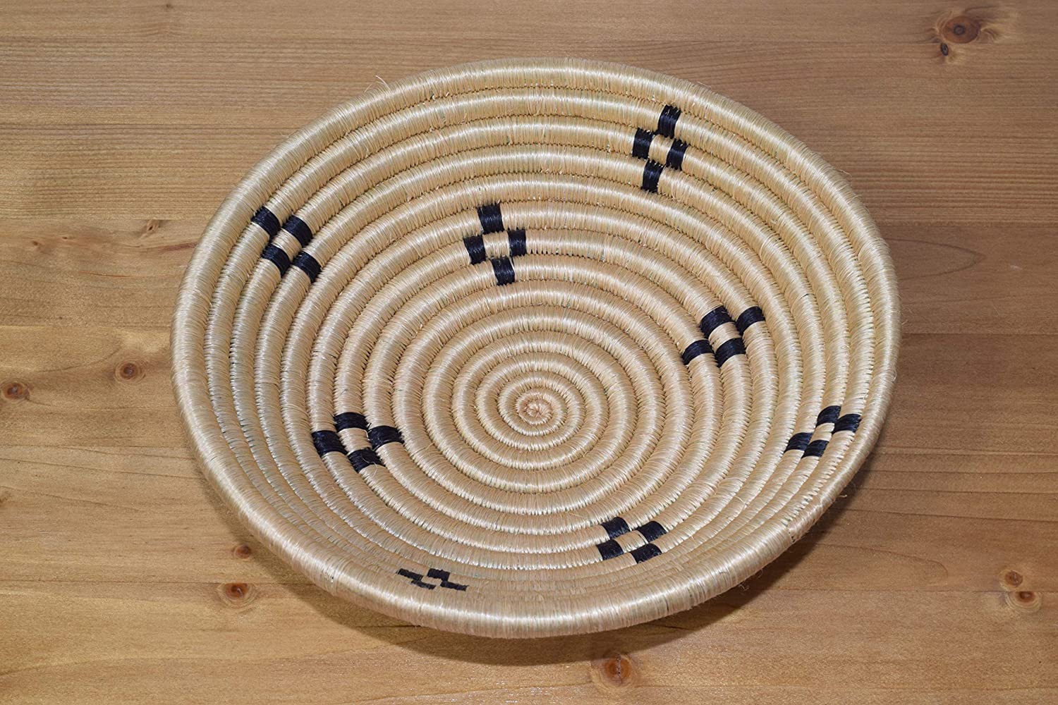 A beautifully handwoven African sisal basket from Rwanda, showcasing intricate patterns and vibrant colors, perfect for home decor or storage.