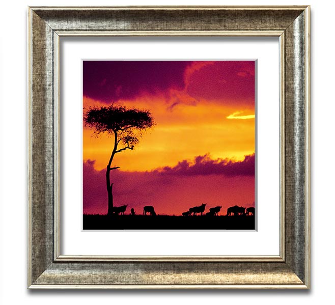 A beautifully framed print of an African sunset, showcasing vibrant colors and serene landscapes, ready to hang.