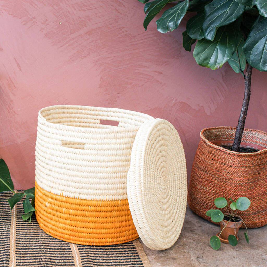 Handwoven African Storage and Laundry Basket in vibrant sunflower yellow and burnt orange colors, showcasing traditional craftsmanship and eco-friendly materials.