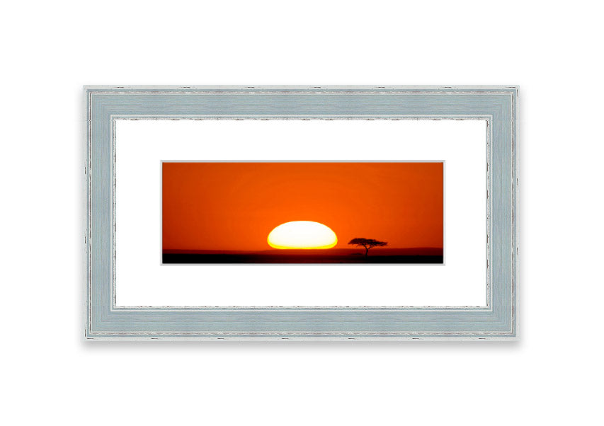 A beautifully framed print of an African sunrise, showcasing vibrant colors and serene landscape, ready to hang.