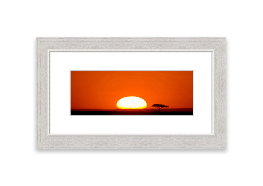 A beautifully framed print of an African sunrise, showcasing vibrant colors and serene landscape, ready to hang.