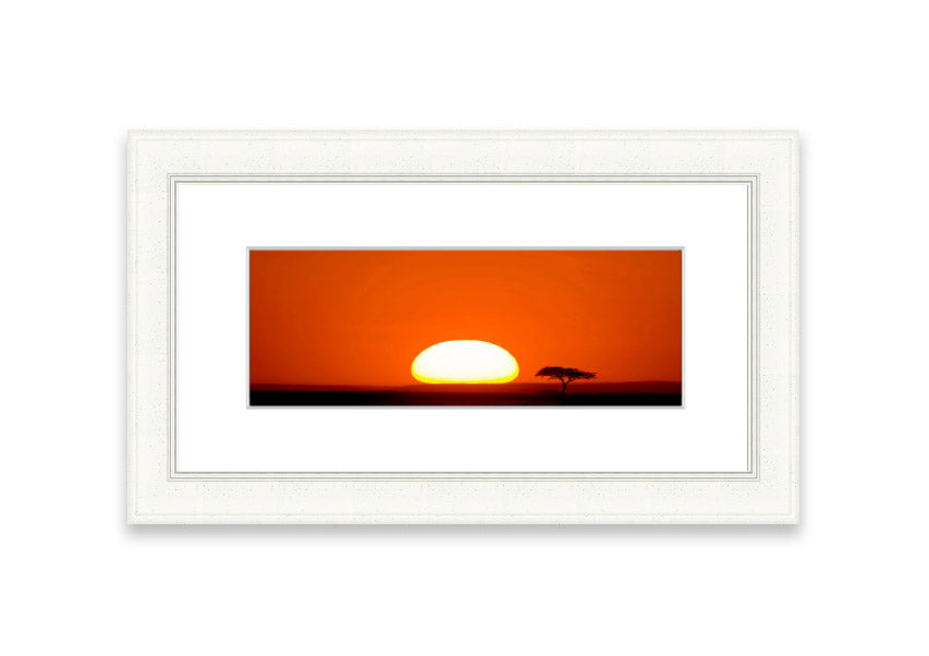 A beautifully framed print of an African sunrise, showcasing vibrant colors and serene landscape, ready to hang.
