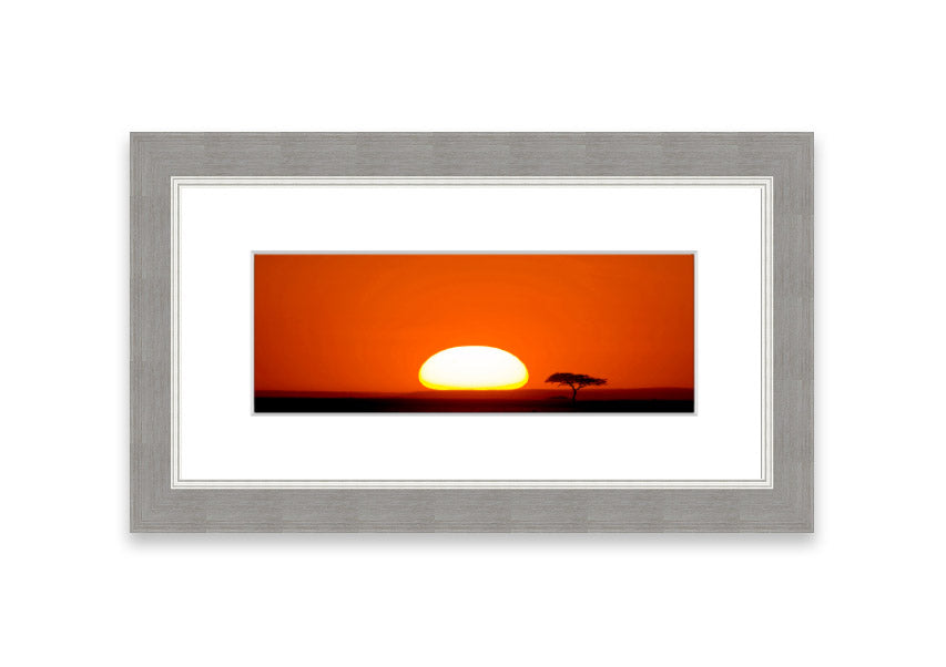 A beautifully framed print of an African sunrise, showcasing vibrant colors and serene landscape, ready to hang.