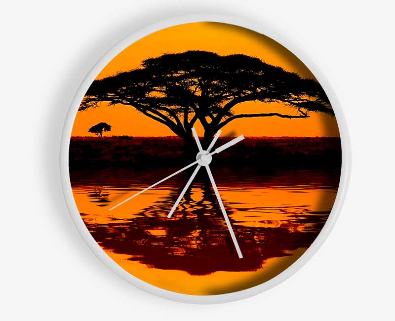 African Tree Reflection clock made from natural bamboo with a round face and clear Plexiglas lens, available in multiple colors.