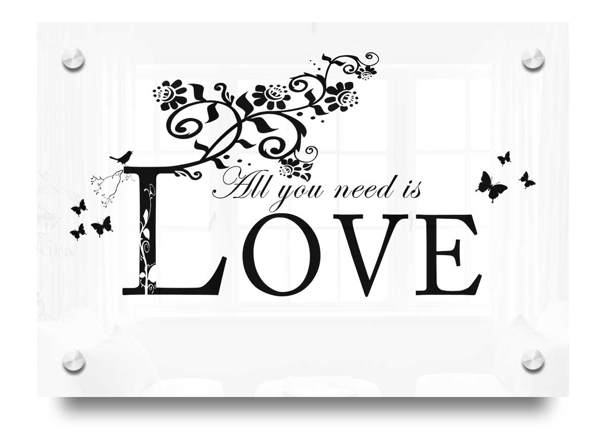 All You Need Is Love White acrylic print on a wall, showcasing vibrant colors and a heartfelt message.