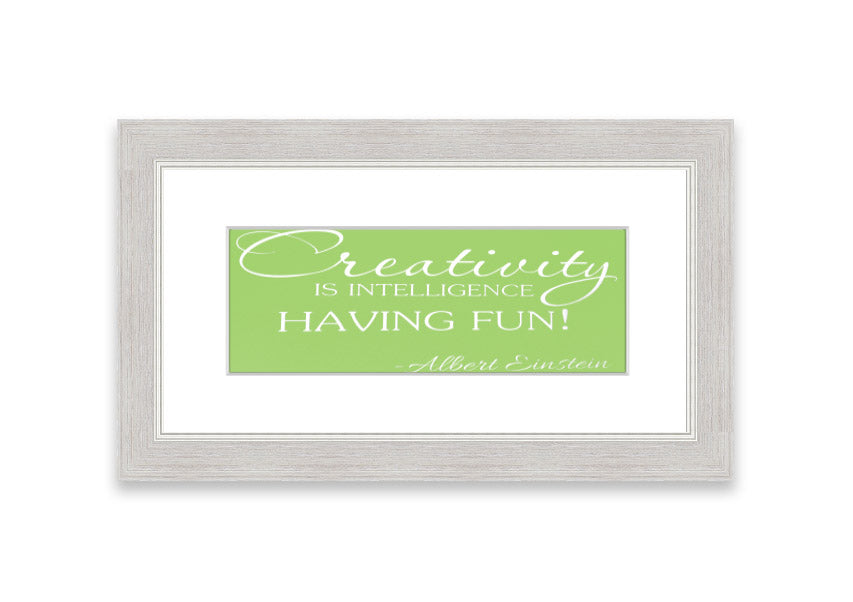 Framed print featuring Albert Einstein's quote 'Creativity Is Intelligence' in vibrant lime green, ready to hang.