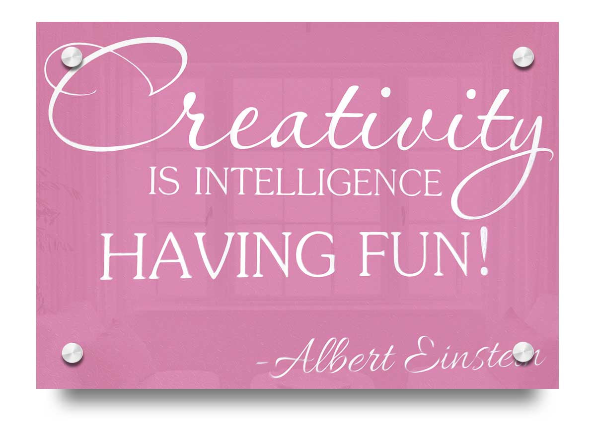 Albert Einstein Creativity Is Intelligence Pink acrylic print on a wall, featuring a vibrant pink background and inspirational quote.