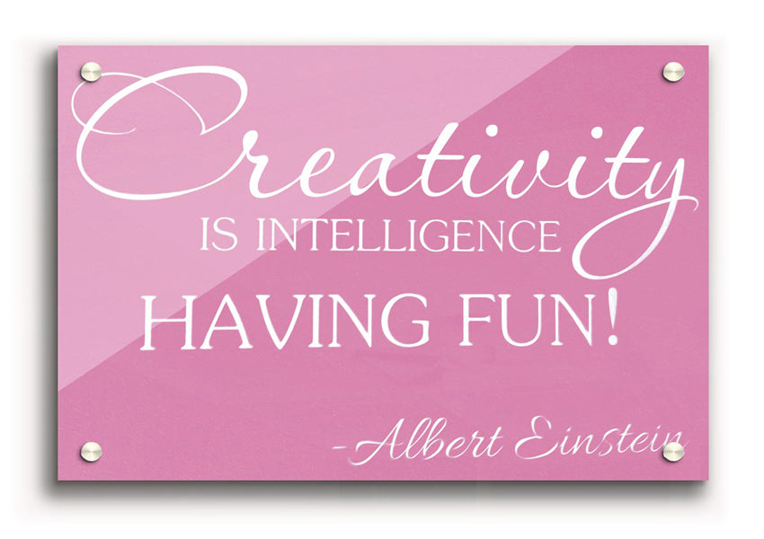 Albert Einstein Creativity Is Intelligence Pink acrylic print on a wall, featuring a vibrant pink background and inspirational quote.
