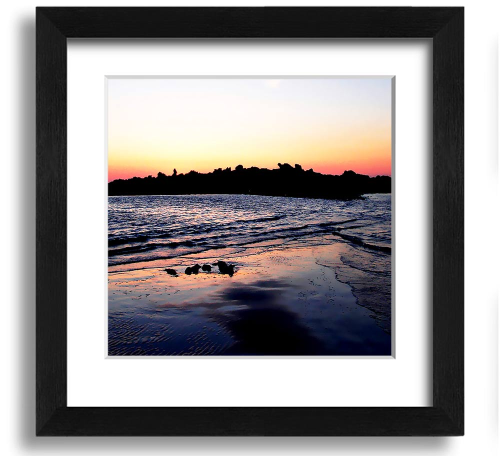 A beautifully framed square print depicting a serene coastal landscape, handmade in the UK, available in various frame colors.