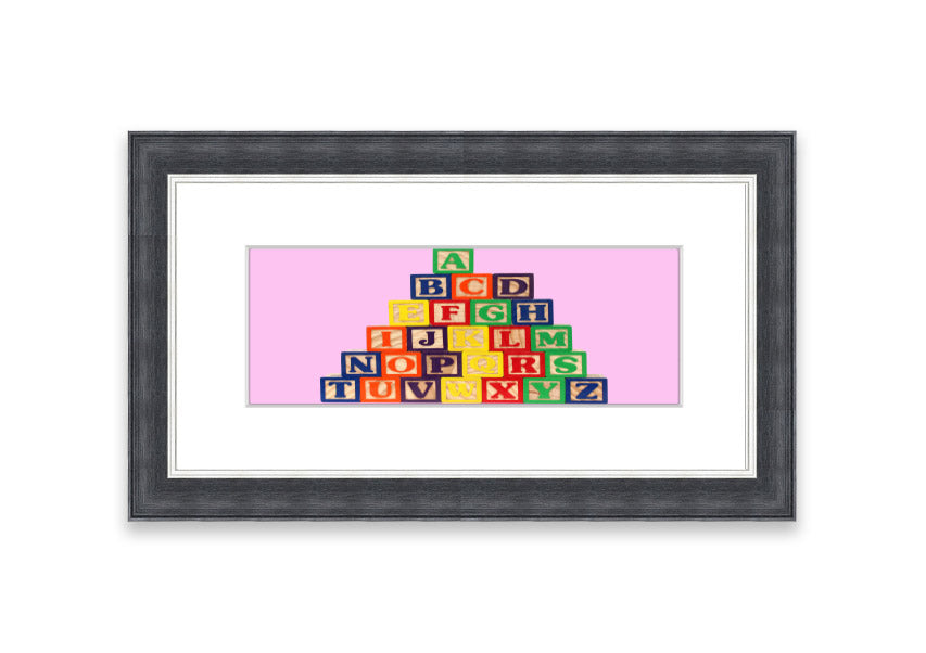 A charming pink framed print featuring colorful alphabet blocks, perfect for children's rooms.