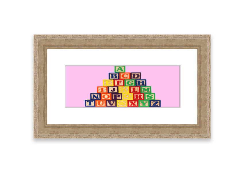 A charming pink framed print featuring colorful alphabet blocks, perfect for children's rooms.