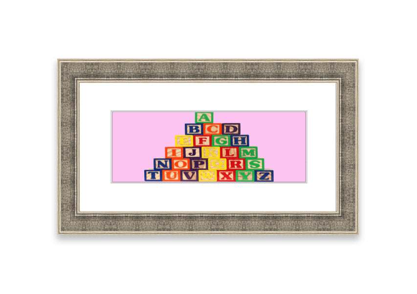 A charming pink framed print featuring colorful alphabet blocks, perfect for children's rooms.