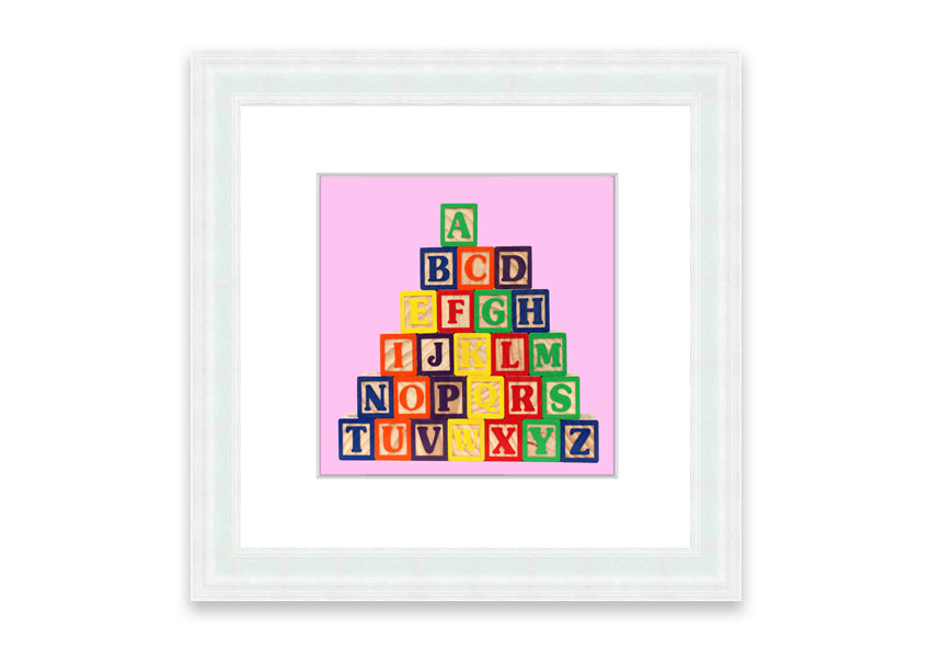 A charming pink framed print featuring colorful alphabet blocks, perfect for children's rooms.