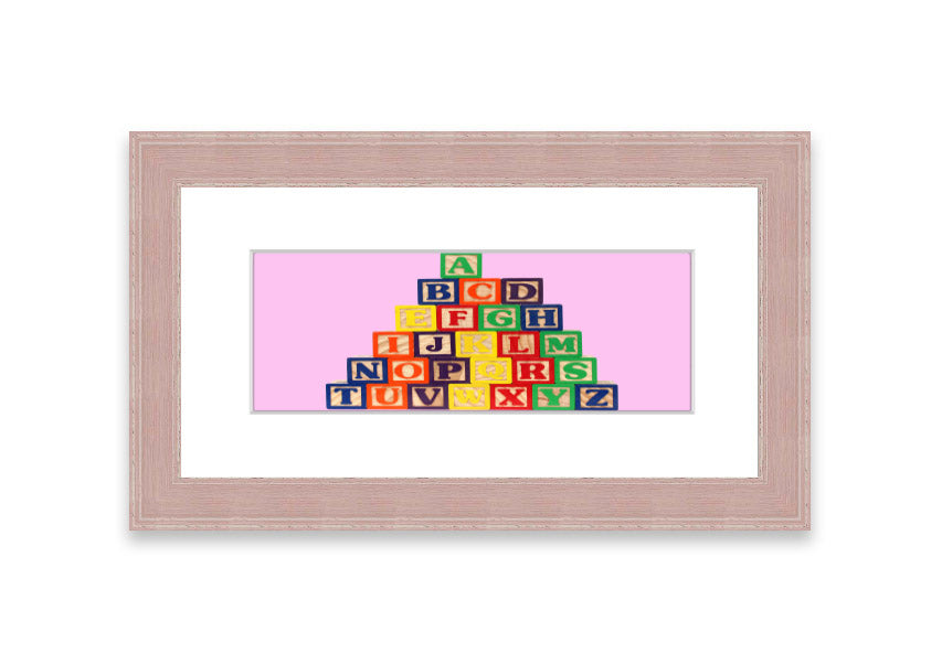 A charming pink framed print featuring colorful alphabet blocks, perfect for children's rooms.