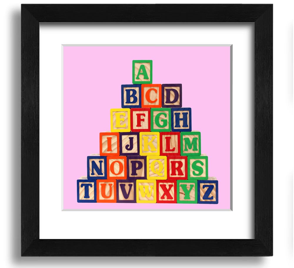A charming pink framed print featuring colorful alphabet blocks, perfect for nursery decor.