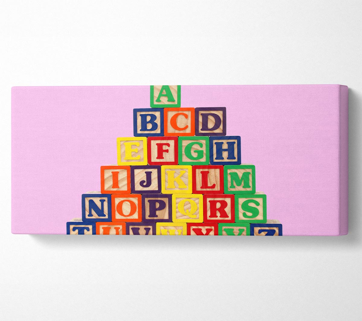 A vibrant pink canvas featuring colorful alphabet blocks, mounted on a sturdy box frame, perfect for nursery decor.