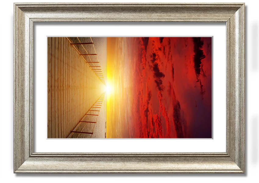 A beautifully framed print of a sunset over a boardwalk, showcasing vibrant colors and serene scenery.