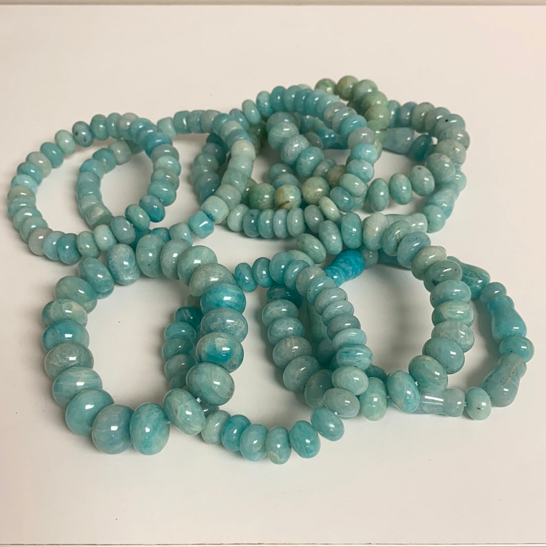 A beautifully crafted Amazonite Mixed Shape Bracelet featuring unique polished stones in various shapes, showcasing its calming blue-green hues.