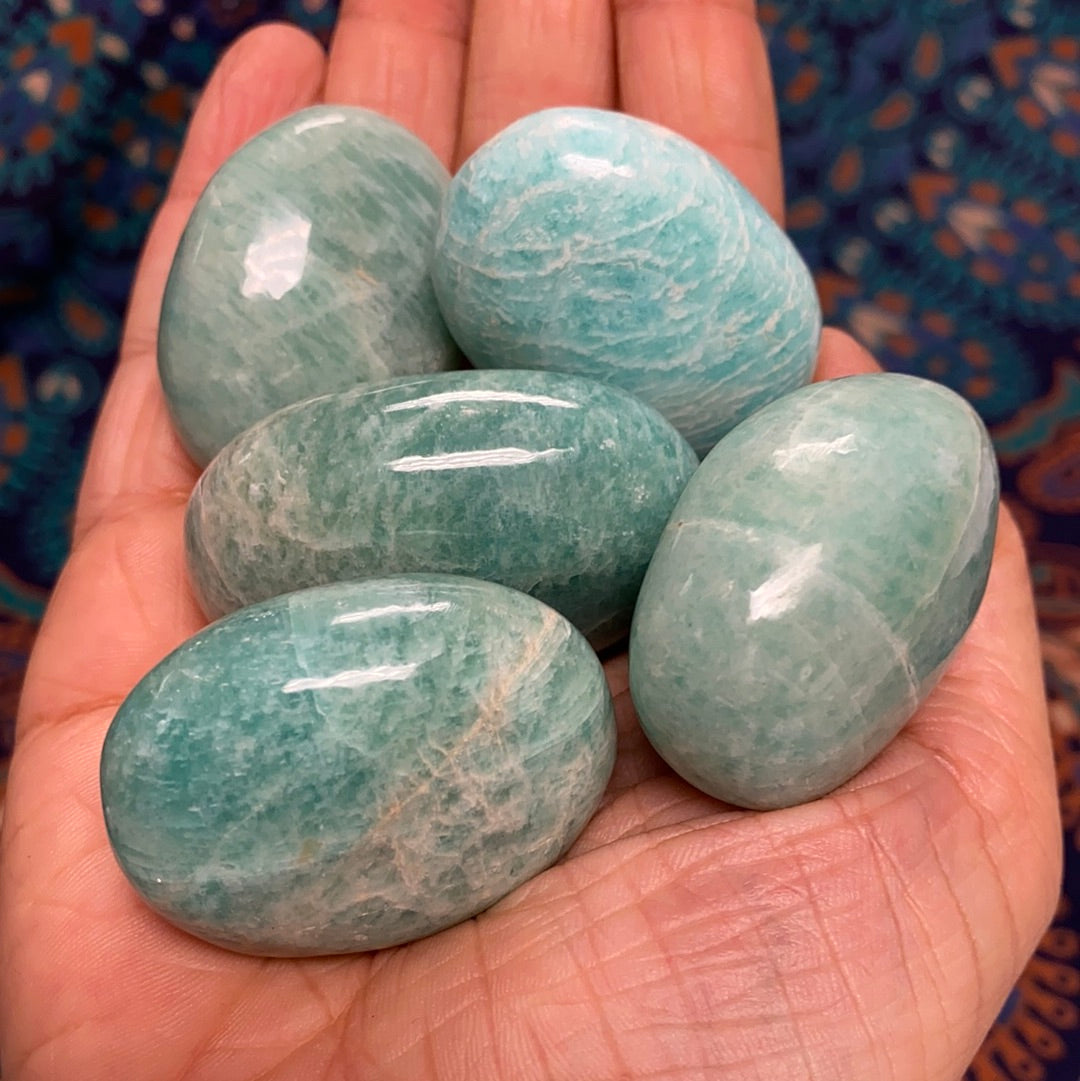 A polished Amazonite Palm Stone showcasing its unique pale aqua color and smooth finish, perfect for healing and meditation.