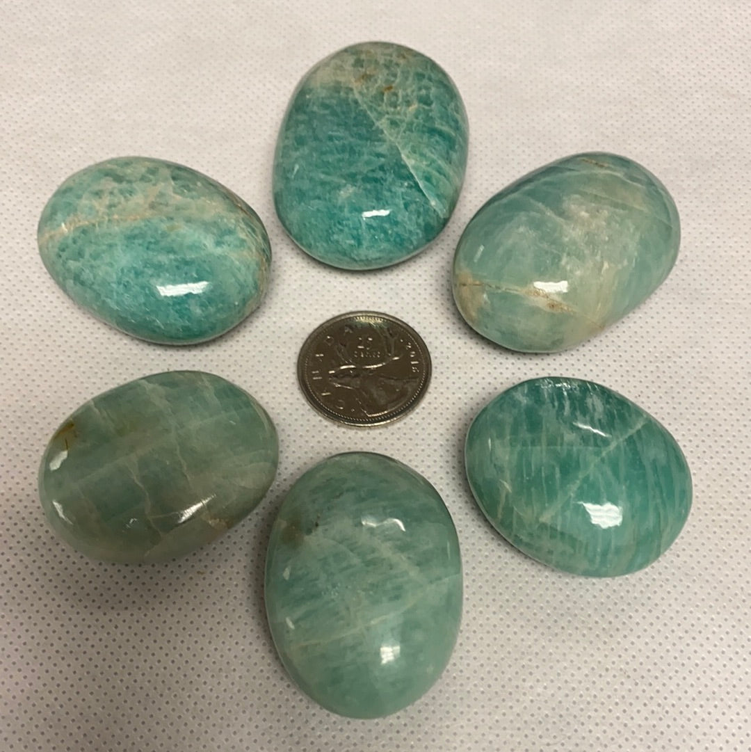 A polished Amazonite Palm Stone showcasing its unique pale aqua color and smooth finish, perfect for healing and meditation.