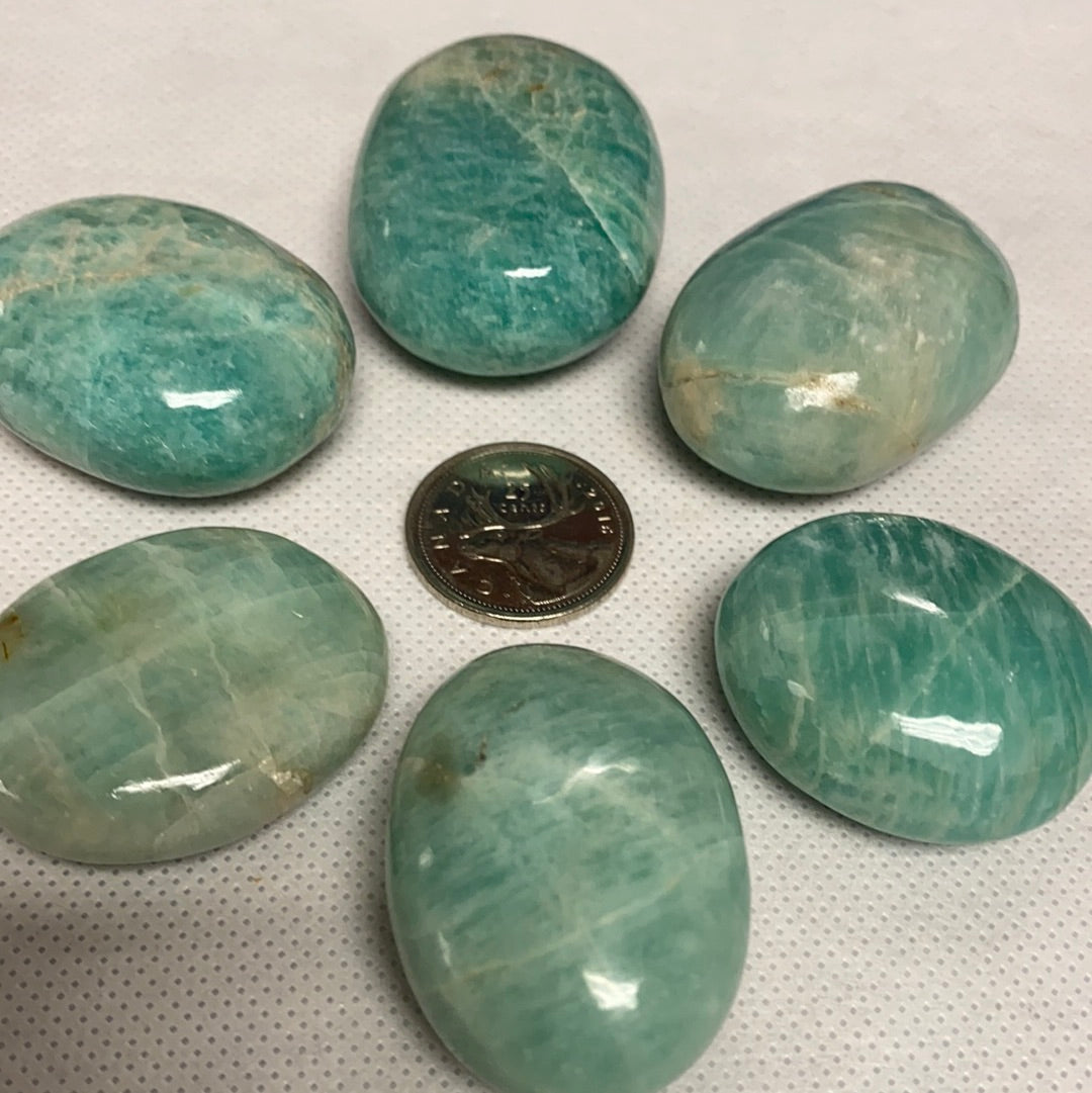 A polished Amazonite Palm Stone showcasing its unique pale aqua color and smooth finish, perfect for healing and meditation.