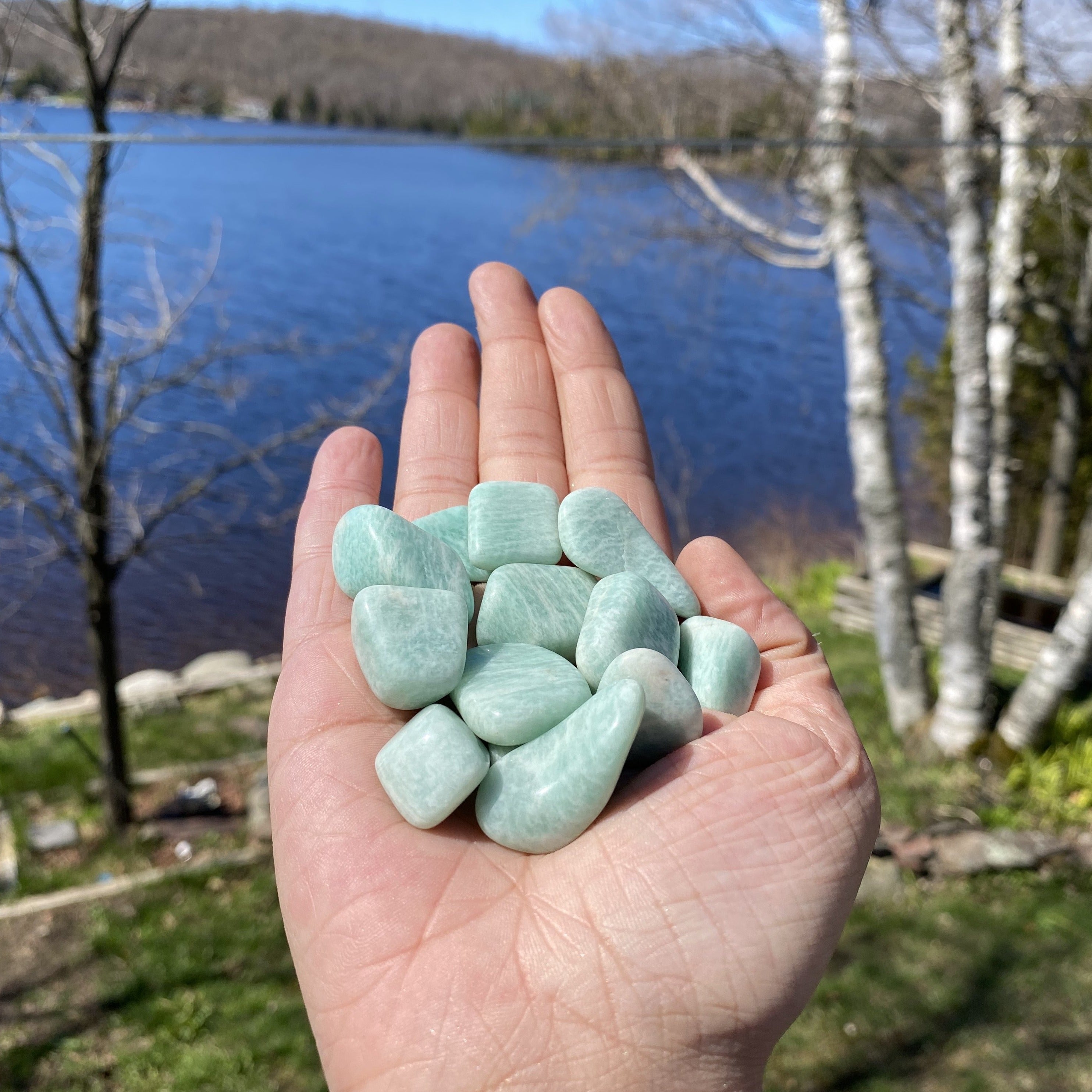 A collection of Amazonite Tumbled Healing Stones showcasing their unique pale aqua colors and natural shapes, perfect for healing and jewelry.