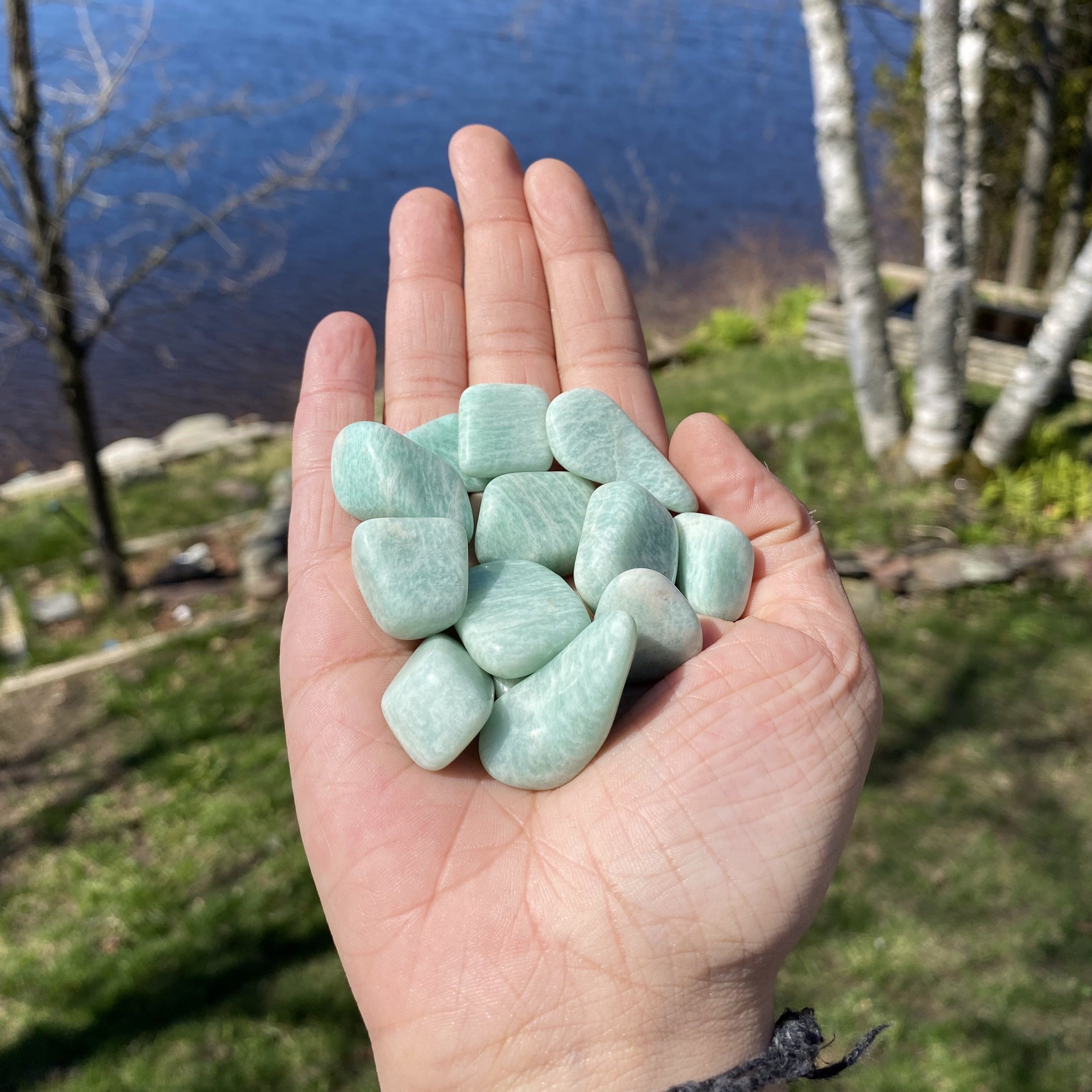 A collection of Amazonite Tumbled Healing Stones showcasing their unique pale aqua colors and natural shapes, perfect for healing and jewelry.