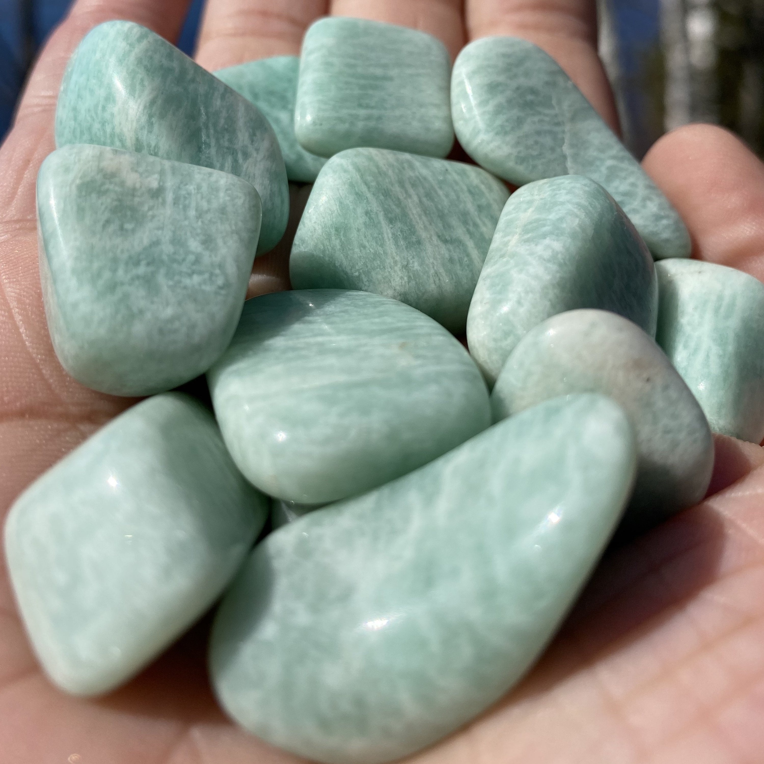 A collection of Amazonite Tumbled Healing Stones showcasing their unique pale aqua colors and natural shapes, perfect for healing and jewelry.