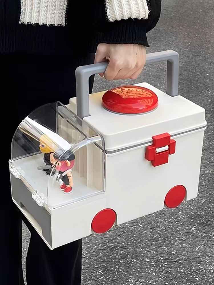 Cute ambulance-shaped first aid kit for organizing pills and supplements with transparent cabinet and portable pillbox.