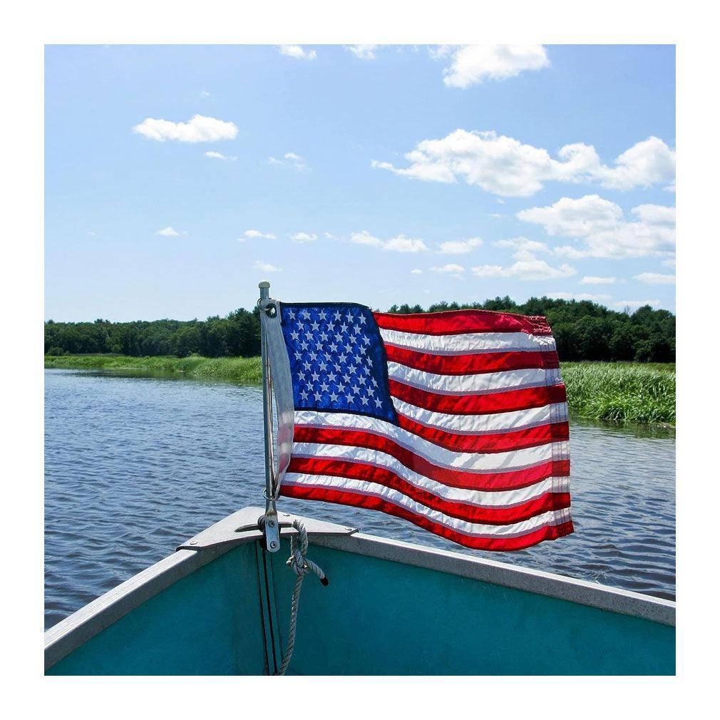 12x18 inch American flag made of heavy-duty nylon, featuring embroidered stars and sewn stripes, designed for outdoor use with brass grommets.