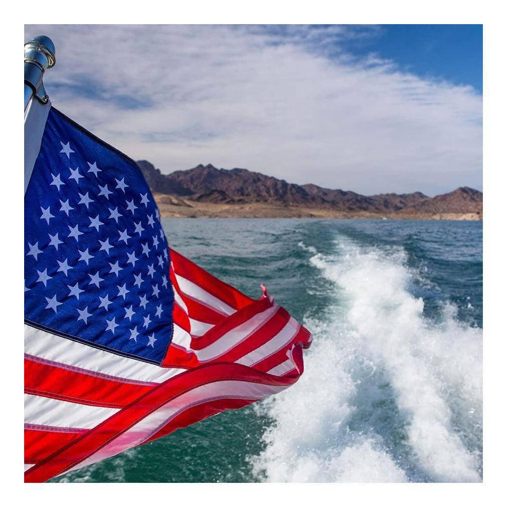 12x18 inch American flag made of heavy-duty nylon, featuring embroidered stars and sewn stripes, designed for outdoor use with brass grommets.