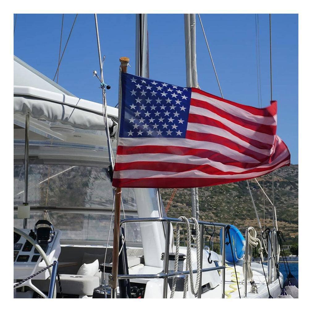12x18 inch American flag made of heavy-duty nylon, featuring embroidered stars and sewn stripes, designed for outdoor use with brass grommets.