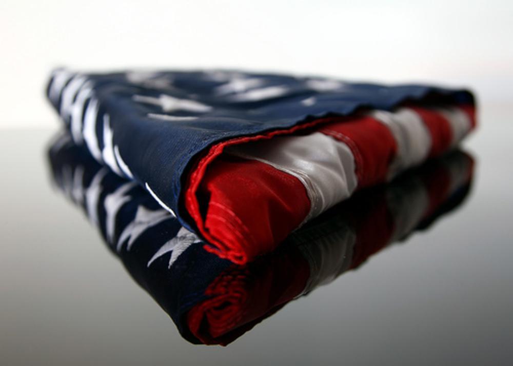 American Flag 5ft x 9.5ft made of heavyweight cotton, featuring vibrant colors and durable craftsmanship, ideal for patriotic displays.