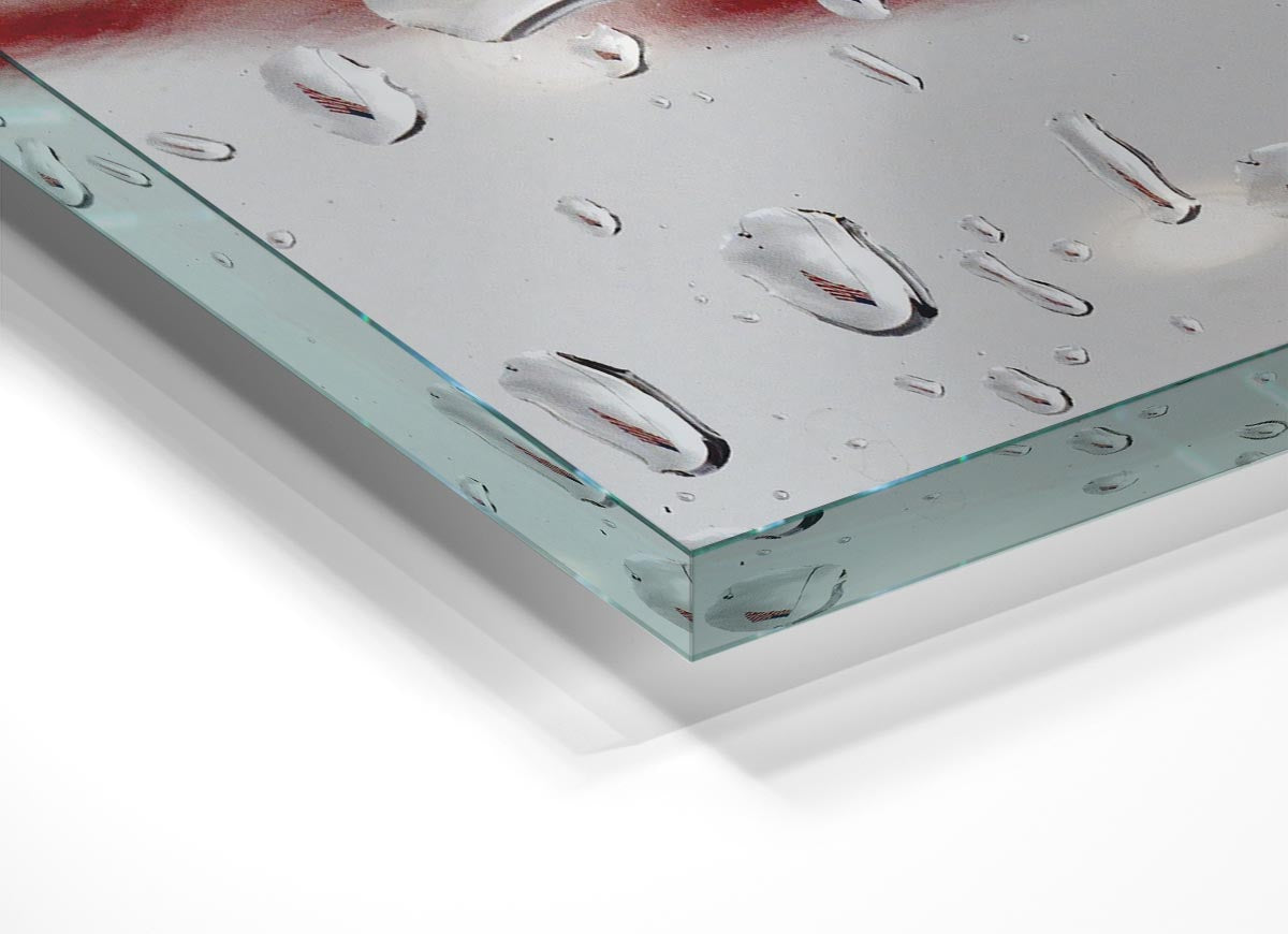 A modern glass print featuring the American flag in a droplet shape, showcasing vibrant colors and contemporary design.