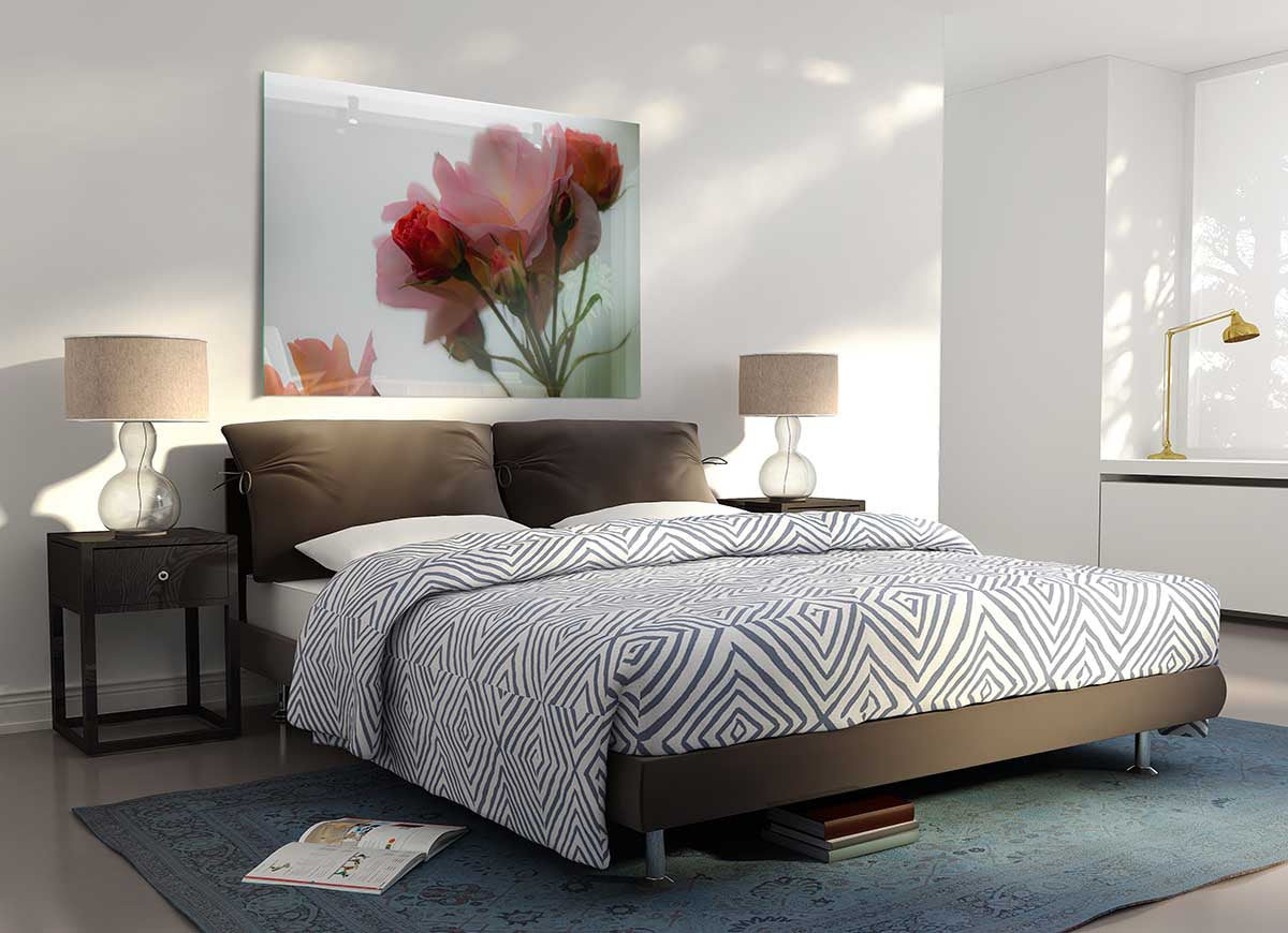 A modern glass print featuring an array of vibrant pink flowers, perfect for home decor.